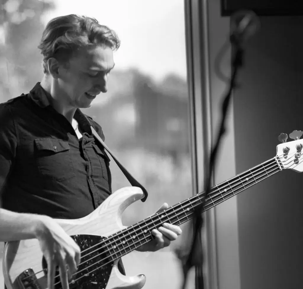 Black and white photo of Hayden playing bass