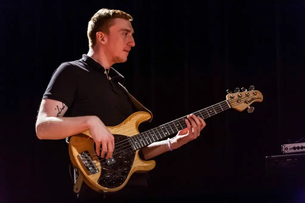 Hayden Playing bass in a dark theatre.