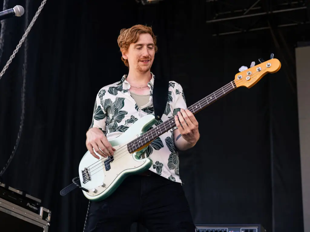 Hayden playing a green bass.